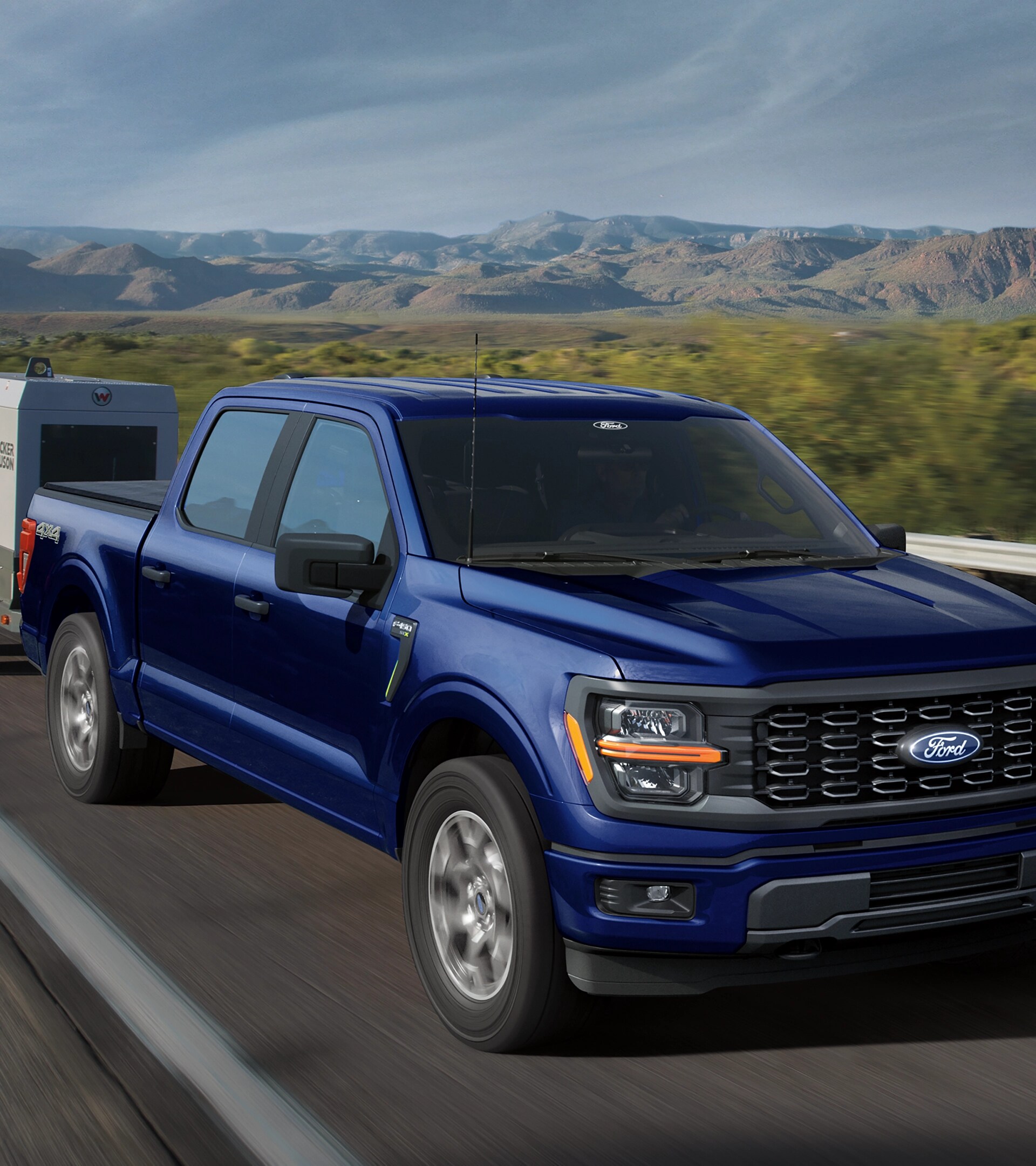 2026 Ford F-150® XL pickup pulling a small trailer