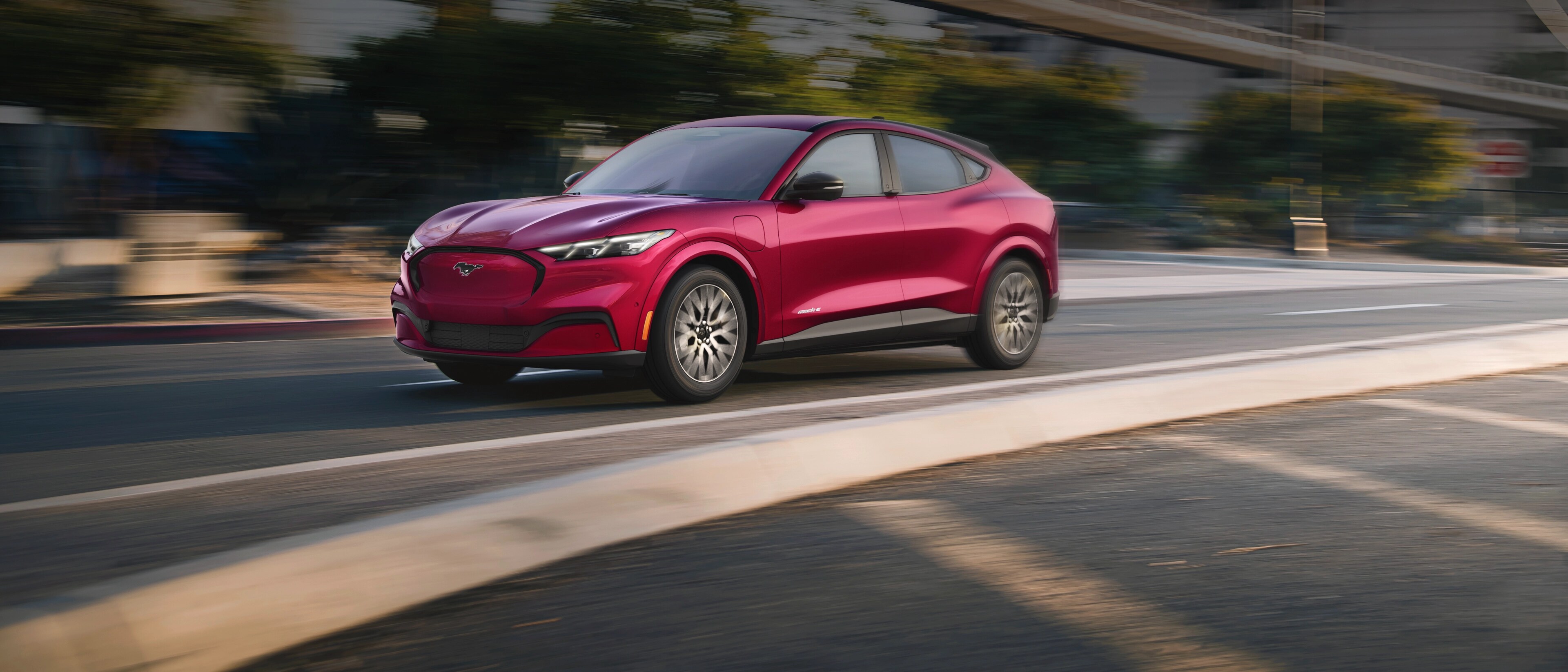 2025 Ford Mustang Mach-E® being driven down a city street