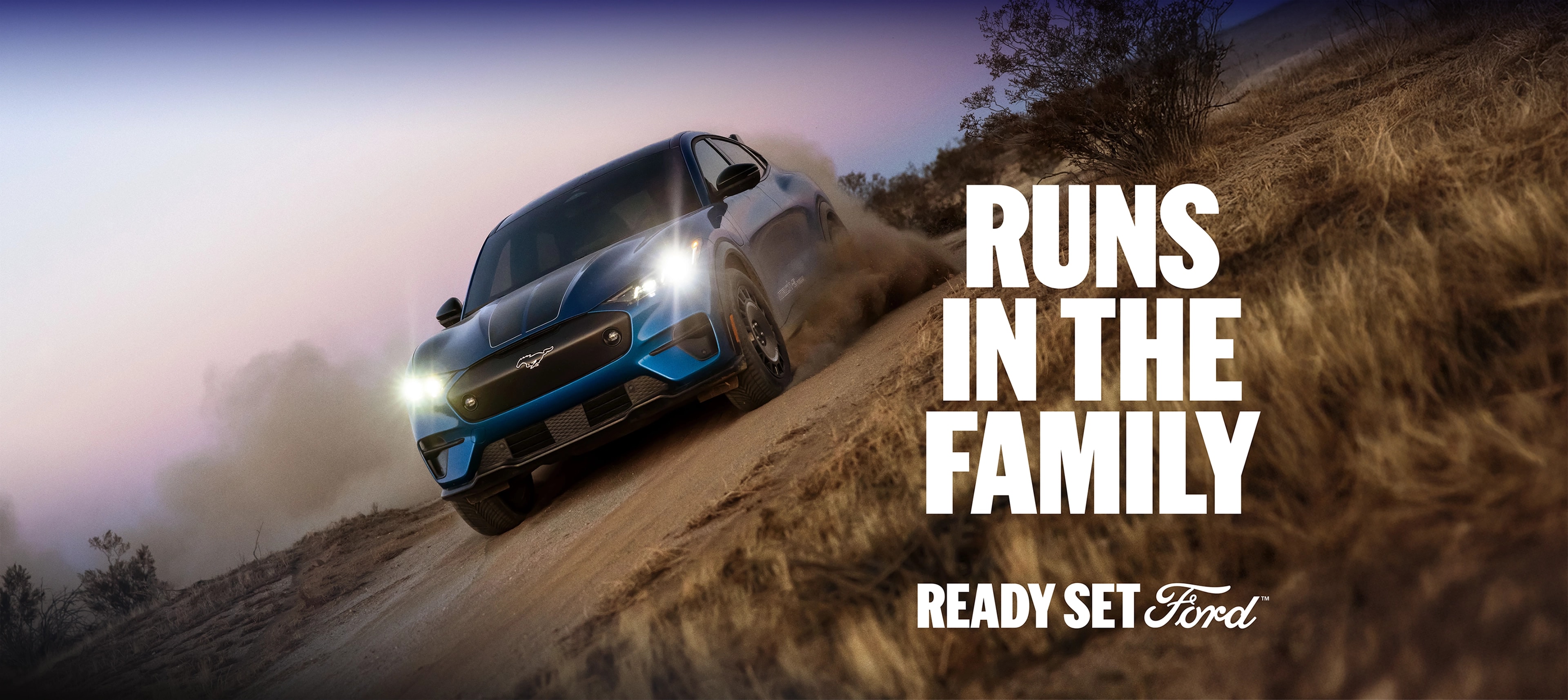 A 2025 Ford Mustang Mach-E® Rally racing on a dirt road