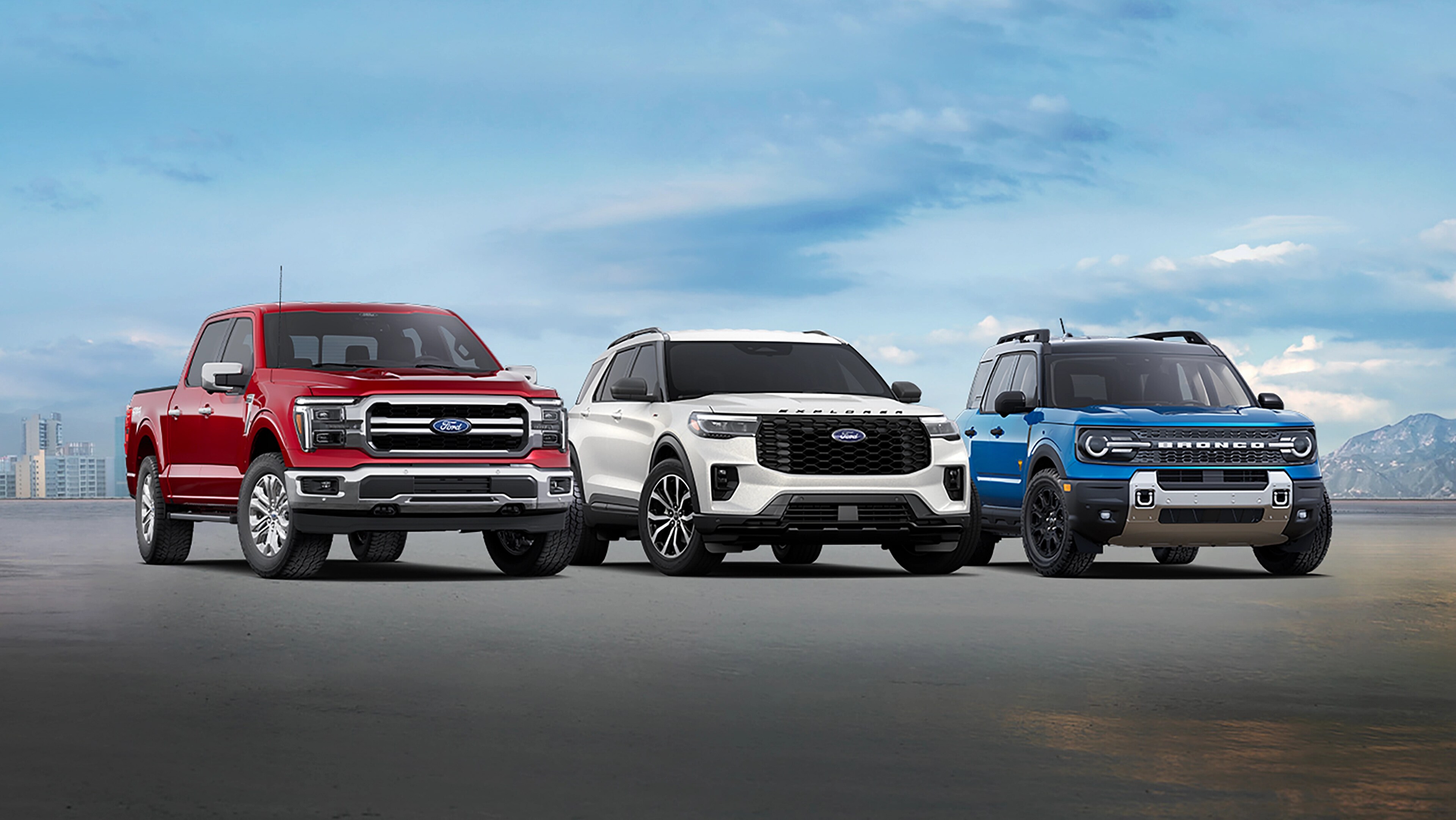 Three car lineup of a red Ford F150®, white Ford Explorer®, and blue Ford Bronco®
