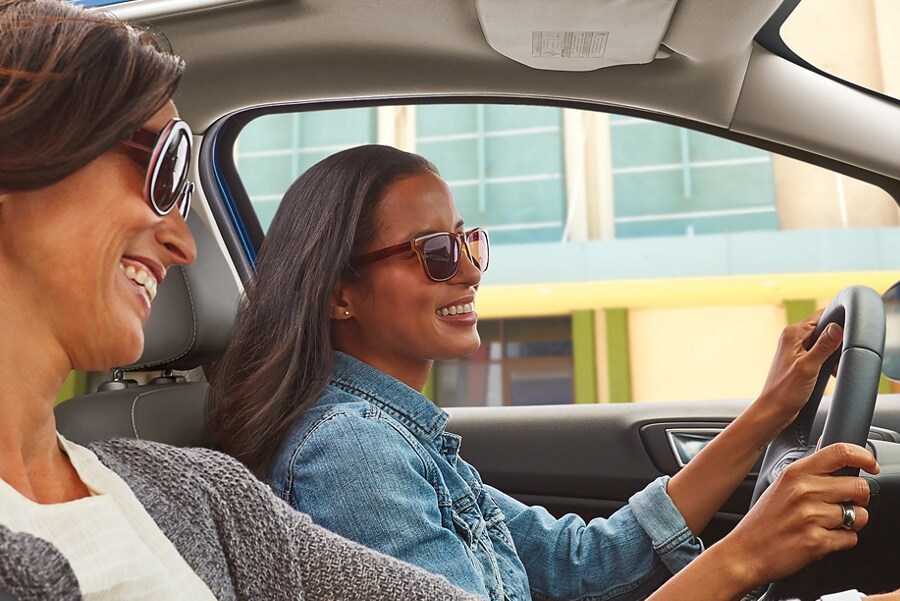 A driver and passenger in a Ford vehicle