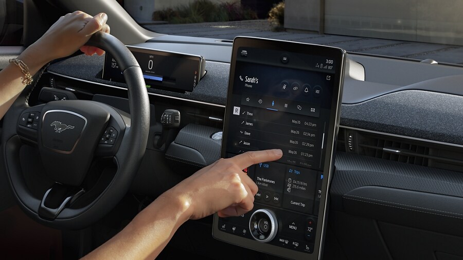 Person interacting with a touchscreen in a 2021 Mustang Mach-E