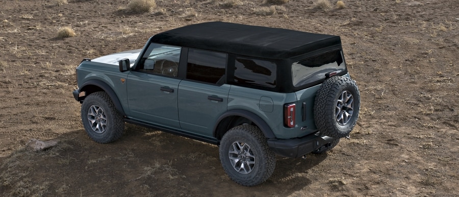 Four-door 2023 Ford Bronco® Badlands® model shown in Azure Gray with soft-top roof