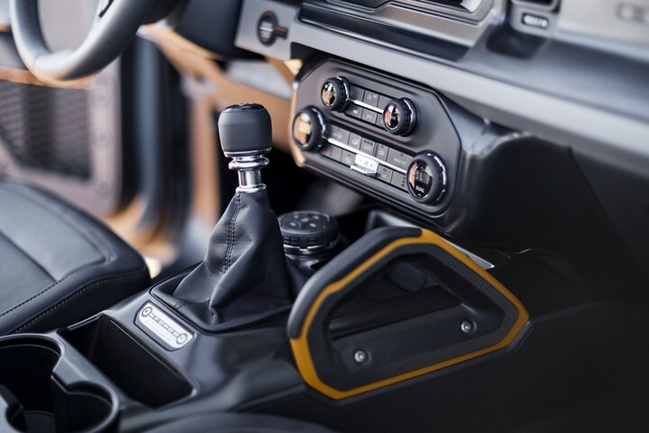 Interior of 2024 Ford Bronco® showing available customizable front passenger-side grab handle