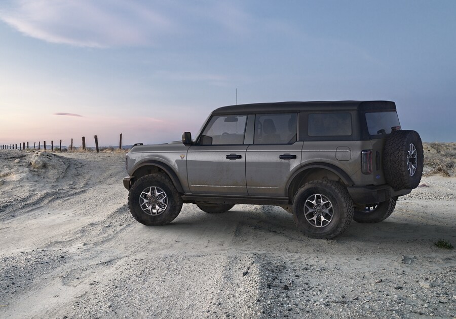 Four-door 2024 Ford Bronco® Badlands® model parked on a desert sand dune