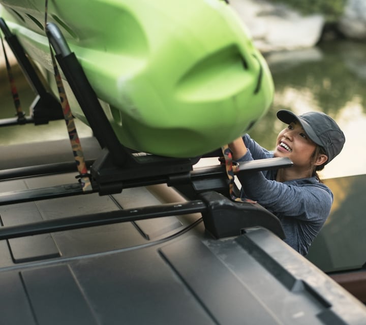 Close-up of a woman loading a kayak on 2024 Ford Bronco® roof