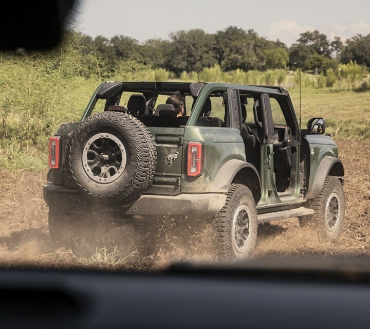 A 2024 Ford Bronco® Outer Banks® with Sasquatch® package seen through another Bronco windshield