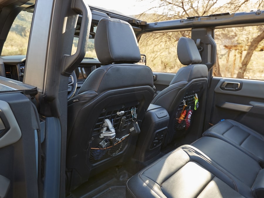 Interior of a 2024 Ford Bronco® showing the MOLLE pockets on back of front seats
