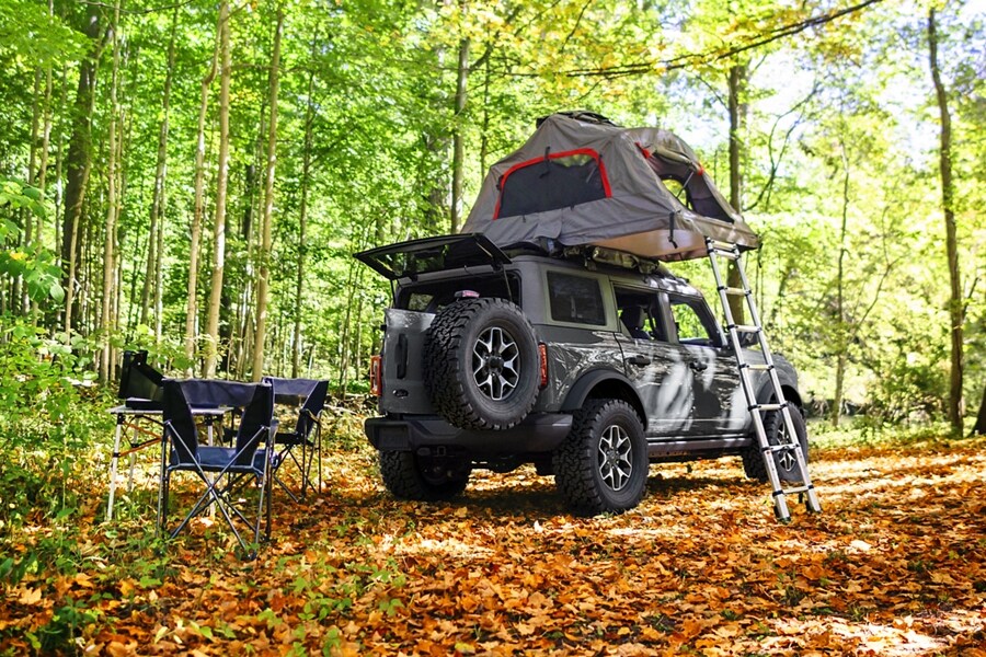A four-door 2024 Ford Bronco® SUV with available roof-mounted Yakima® two-person three-season tent
