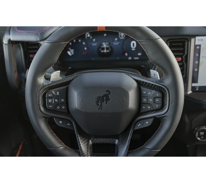 Close-up of a 2024 Ford Bronco® Raptor® steering wheel showing all the control buttons