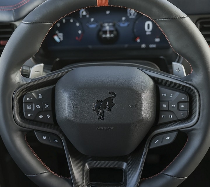 Close-up of a 2024 Ford Bronco® Raptor® steering wheel showing all the control buttons