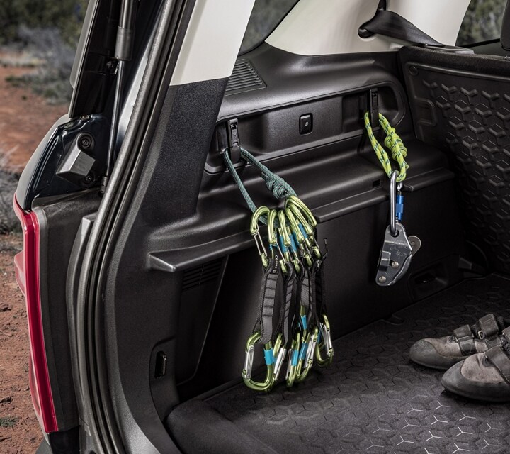 Close-up of a piece of equipment tied down using carabiner hooks and loops