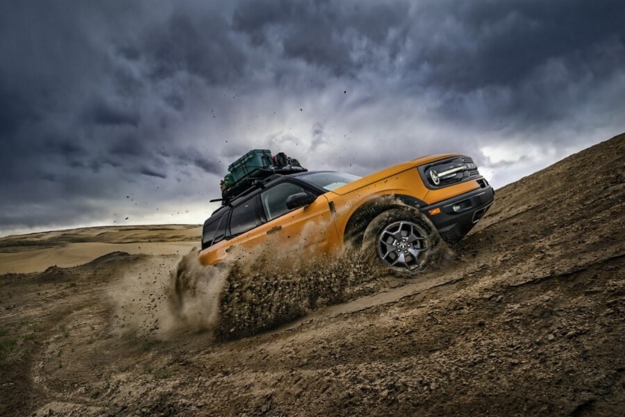 A 2023 Ford Bronco® Sport SUV being driven up a dirt hill