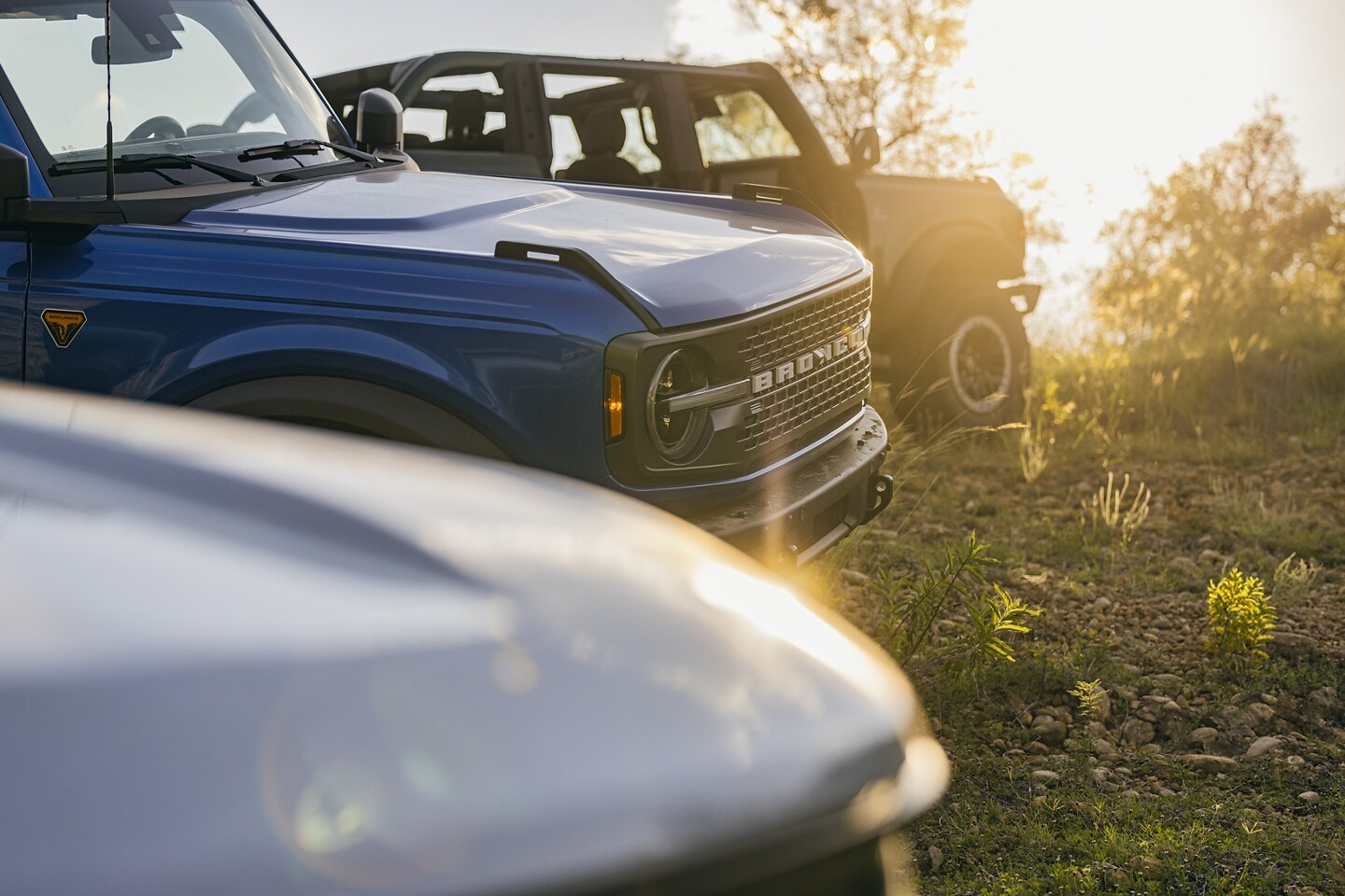 Several 2024 Ford Bronco® vehicles parked on the grass with the doors removed