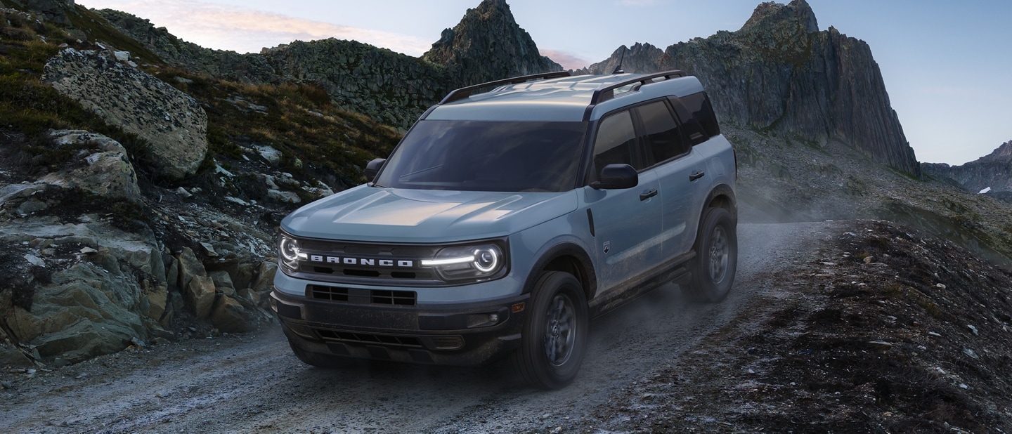 A 2024 Ford Bronco® Sport SUV being driven on road with rock formations visible outside the vehicle