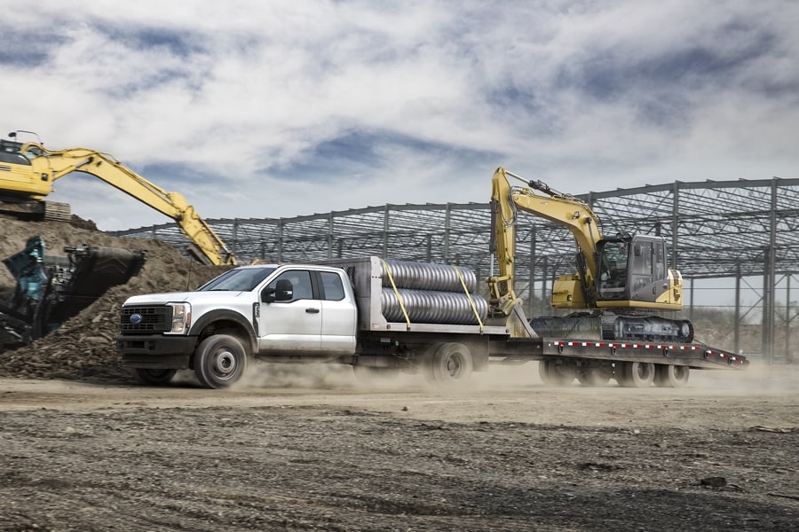 2023 Ford Super Duty® Chassis Cab with upfit at a construction site upfitted and hauling equipment