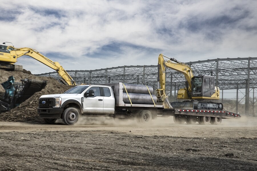 2024 Ford Super Duty® Chassis Cab with upfit at a construction site upfitted and hauling equipment