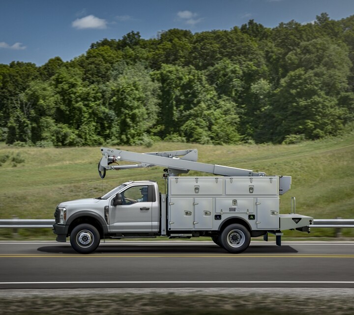 2023 Ford Super Duty® being driven down the highway with bucket upfit