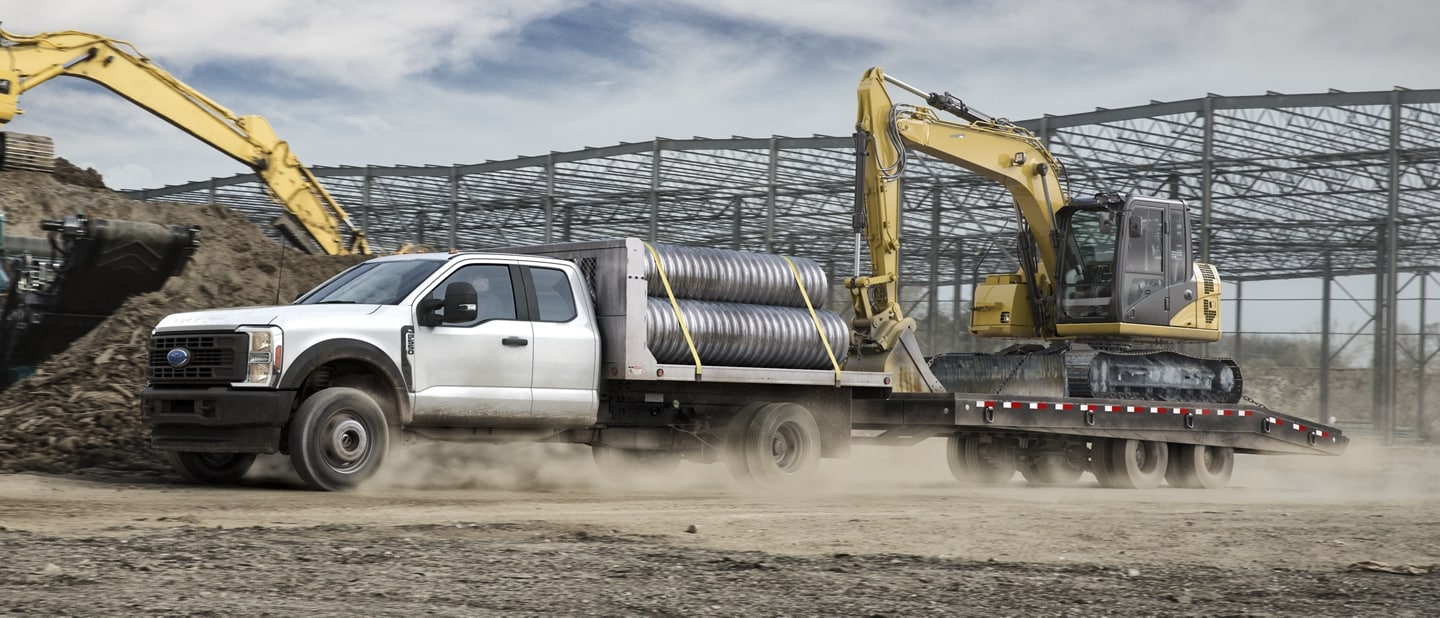2024 Ford Super Duty® Chassis Cab with upfit at a construction site upfitted and hauling equipment