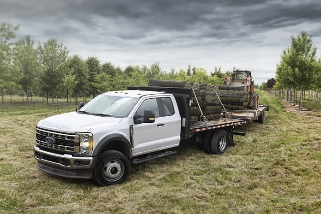 2024 Ford Super Duty® XLT model parked in an orchard with equipment loaded on the flatbed