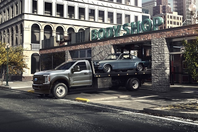 A 2024 Ford Super Duty® F-600® towing a classic car