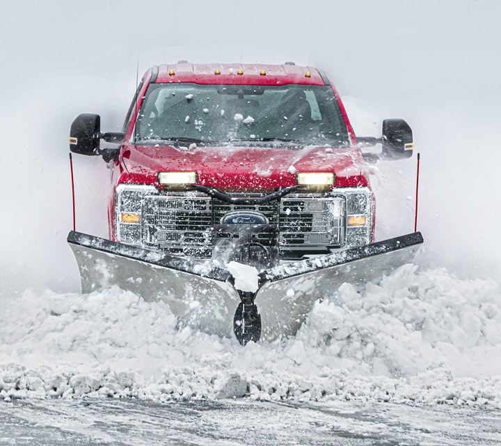 2024 Ford Super Duty® Chassis Cab with snowplow upfit pushing a pile of snow