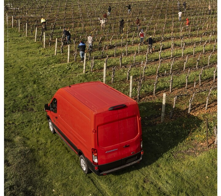 A 2023 Ford E-Transit™ parked at an orchard