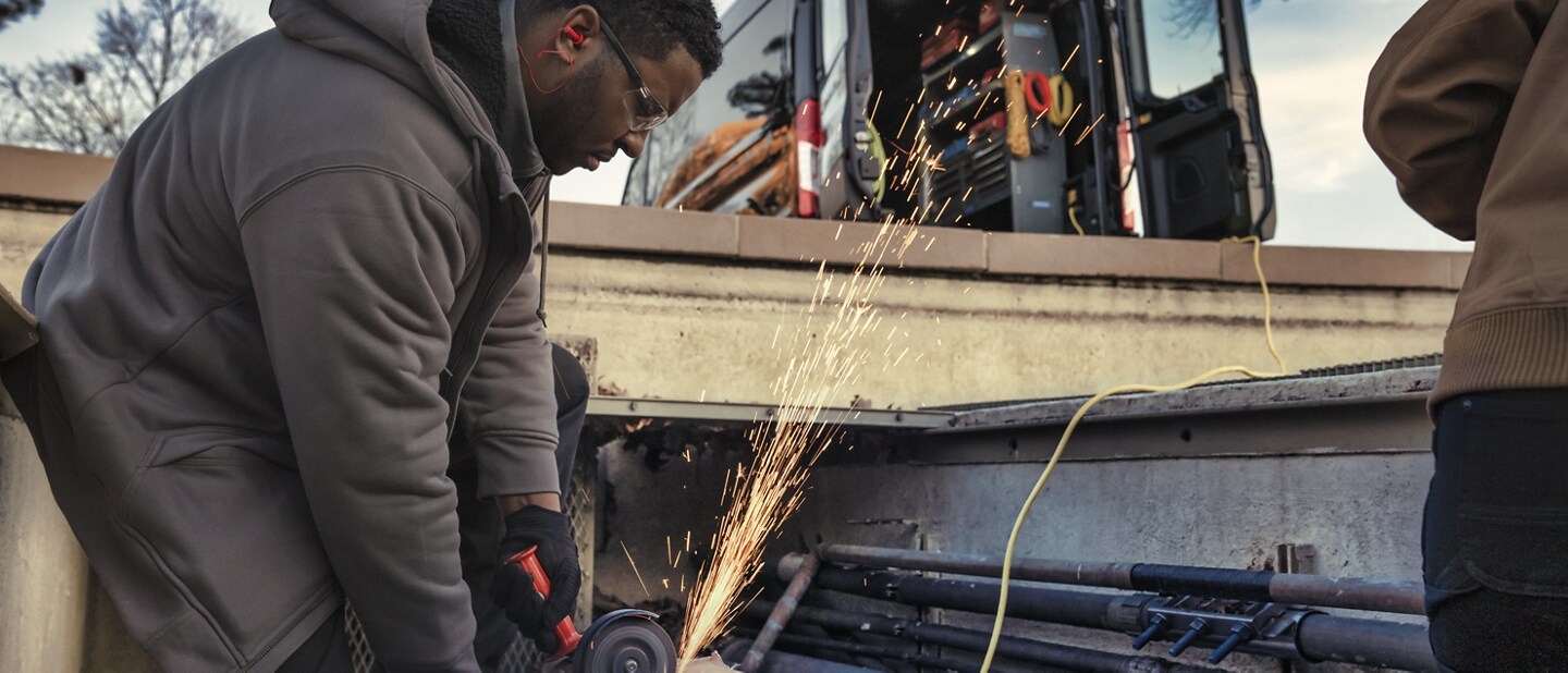 Man using a power tool at a job site