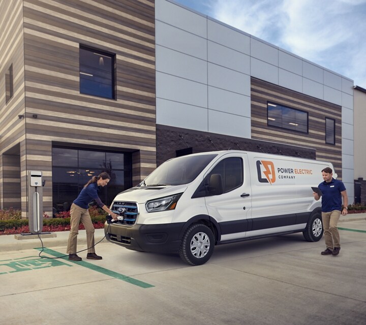 A woman is shown charging a 2024 Ford E-Transit™ vehicle