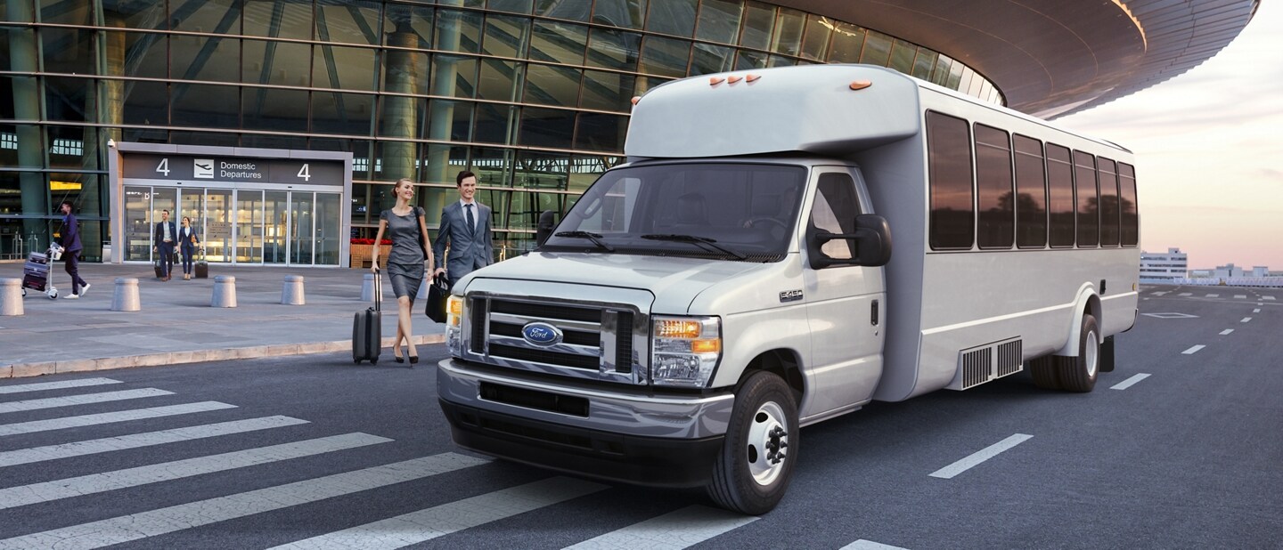 2024 Ford E-Series Cutaway with aftermarket shuttle bus body being driven through underpass