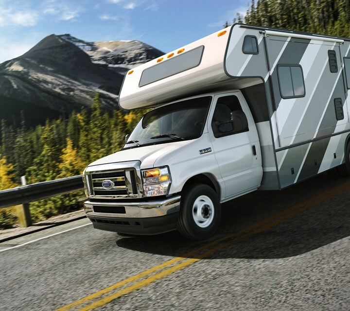 2024 Ford E-Series dual-rear-wheel cutaway with Class C motorhome package being driven on a bridge