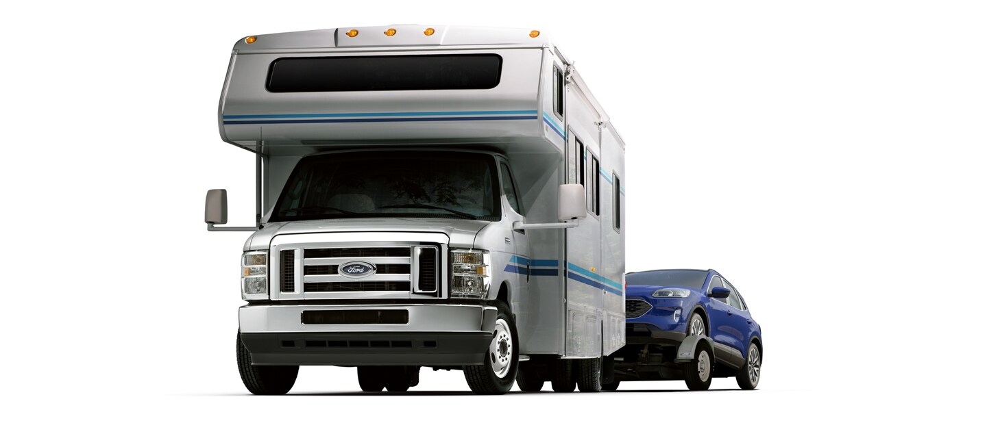 2026 Ford E-Series Cutaway with Class C Motorhome towing a car on a trailer