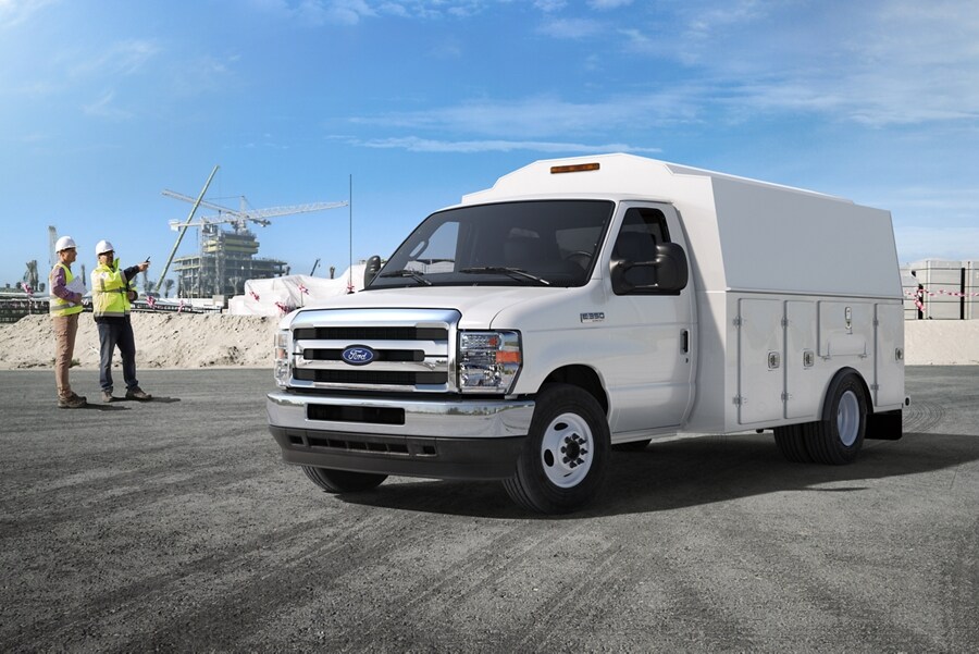 Two construction workers near a 2026 Ford E-Series Cutaway with contractor body upfit