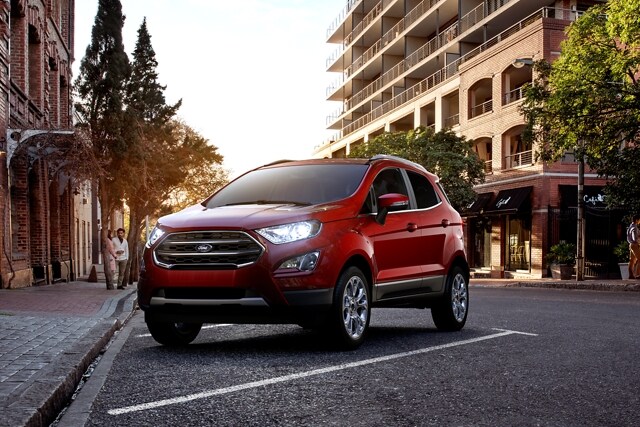 A 2021 Ford EcoSport in ruby red parked in front of a restaurant