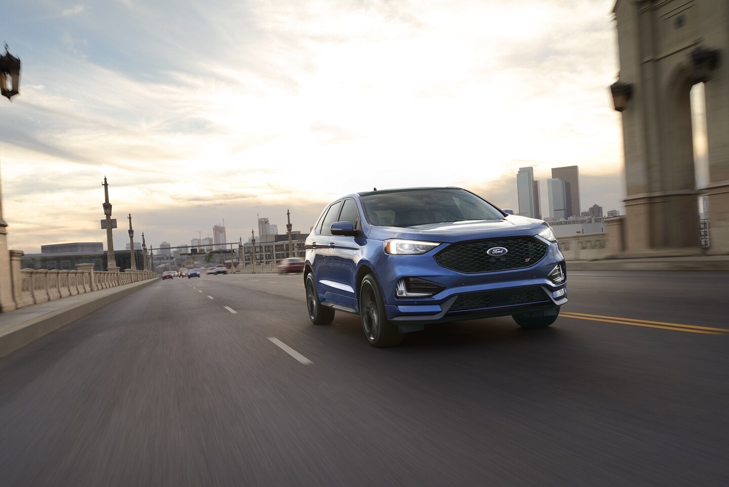2021 Ford Edge Blue 2021 Ford Edge driving away from the city