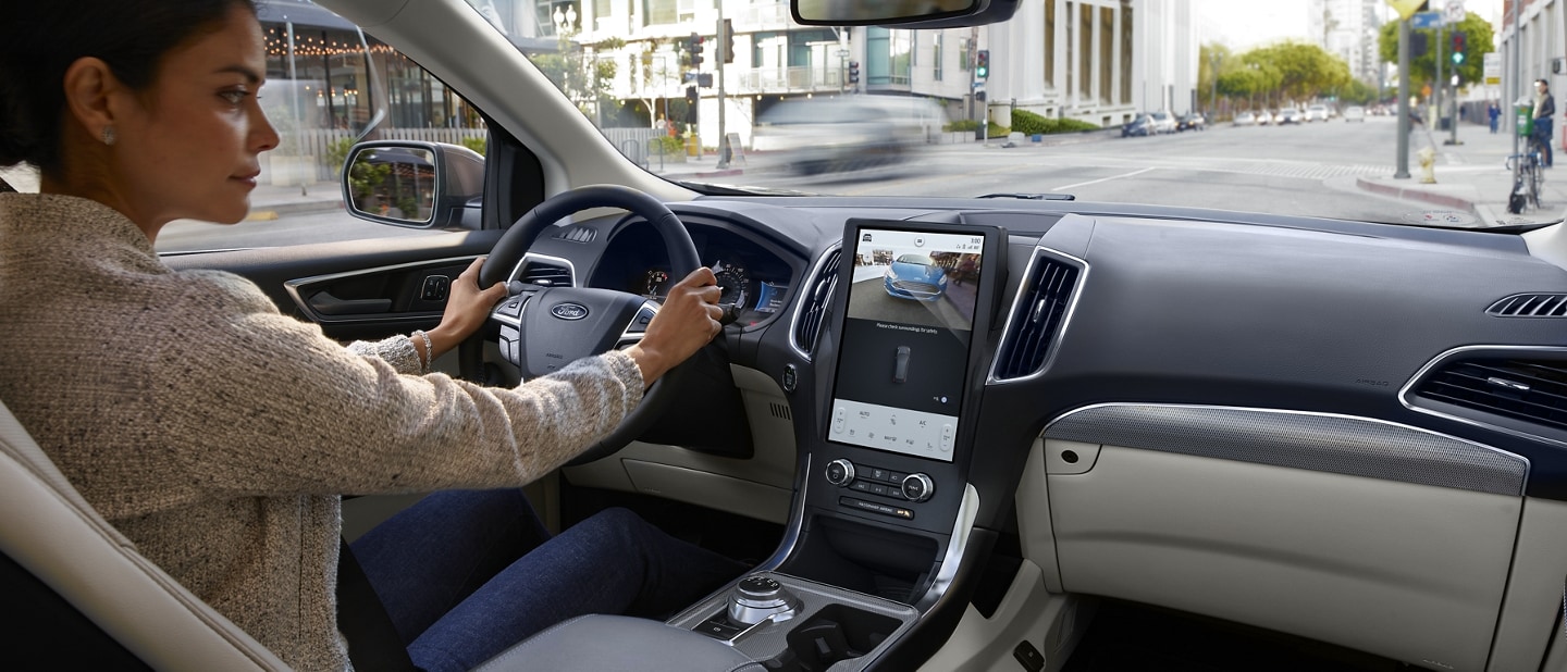 Interior view of the front area of a 2022 Ford Edge with a woman driving