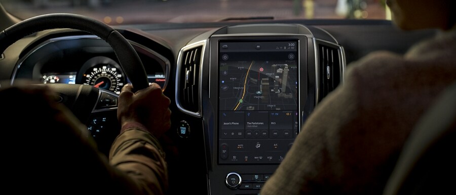 Interior of 2023 Ford Edge® ST-Line at night being driven down city street