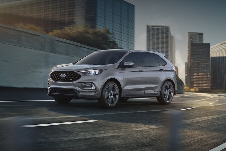 2024 Ford Edge® SUV in Iconic Silver being driven through a city