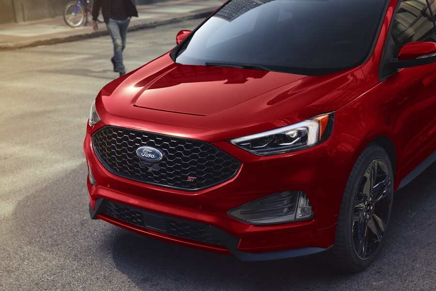 Three-quarter view of the front of a 2024 Ford Edge® ST SUV in Rapid Red