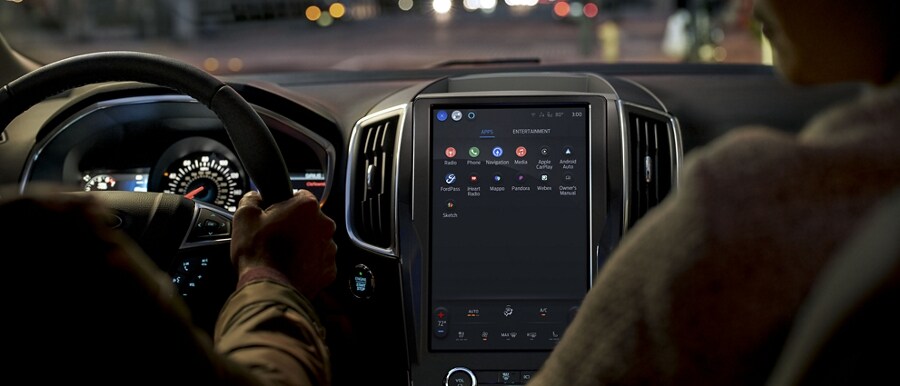 Interior of 2024 Ford Edge® ST-Line at night being driven down city street