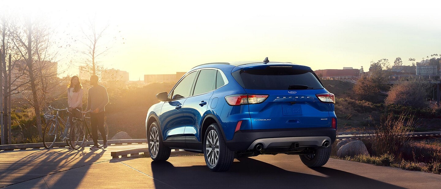 2021 Ford Escape Titanium in Velocity Blue parked near a city bike path