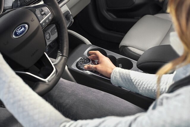 Interior view of 2023 Ford Escape® with driver using the standard rotary gear shift dial