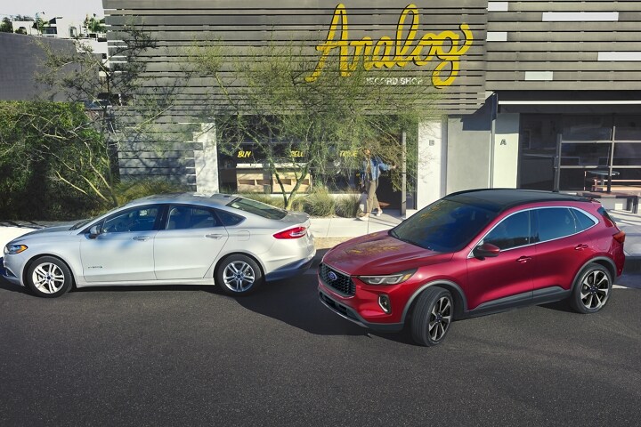 2023 Ford Escape® Rapid Red Metallic Tinted Clearcoat parallel parking in front of a store