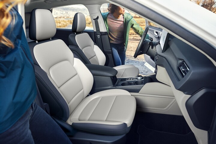 Interior shot of a 2023 Ford Escape® as two people start to enter it