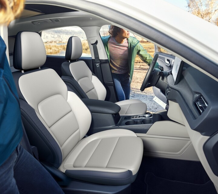 Interior view of a 2023 Ford Escape® SUV with a driver getting inside