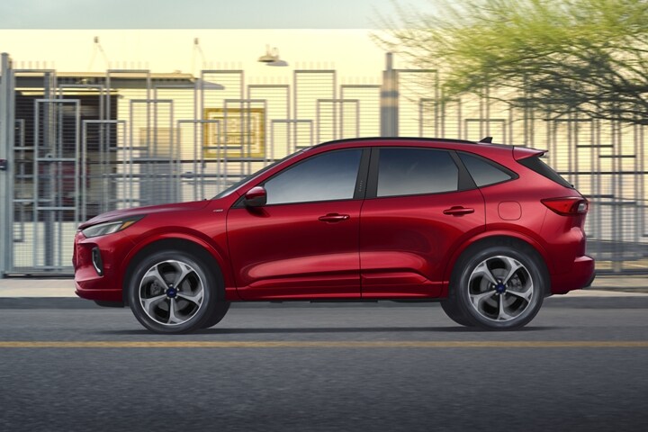 2023 Ford Escape® in Rapid Red Metallic being driven down a road