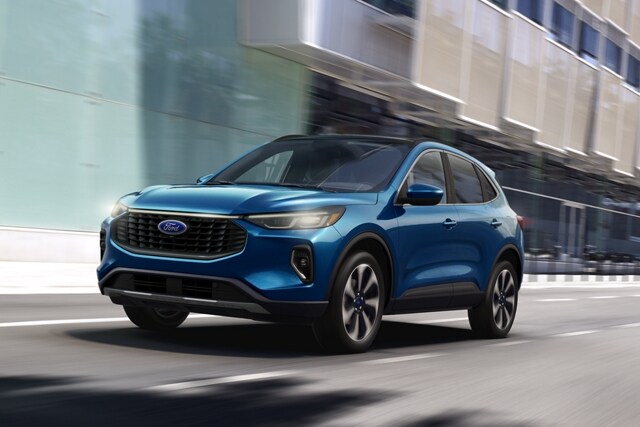 2023 Ford Escape® Platinum in Atlas Blue being driven down a city road