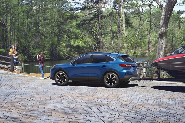 2023 Ford Escape® in Atlas Blue towing a boat