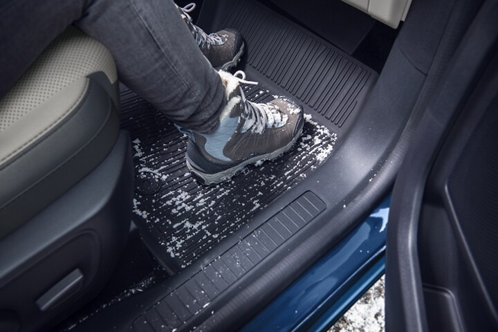 Interior shot of a 2023 Ford Escape® showing the floor mats and dirty boots