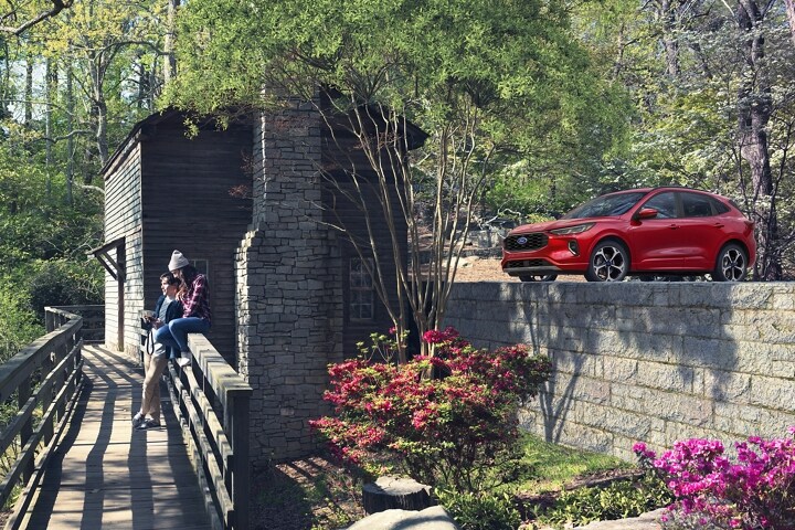 2023 Ford Escape® in Rapid Red Metallic Tinted Clearcoat parked next to a house